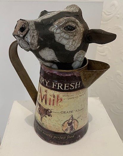 View Cow in milk jug